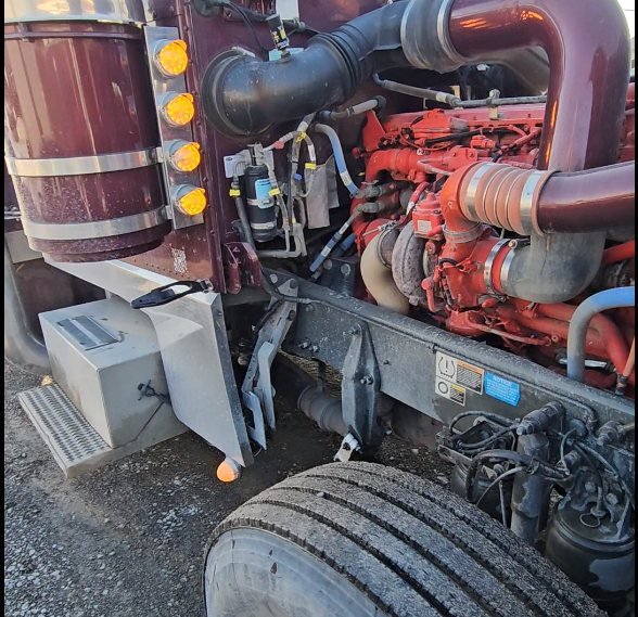 Moteur diesel rouge d'un camion lourd, cabine basculée — la pièce à 75 000 $ que l'huile protège